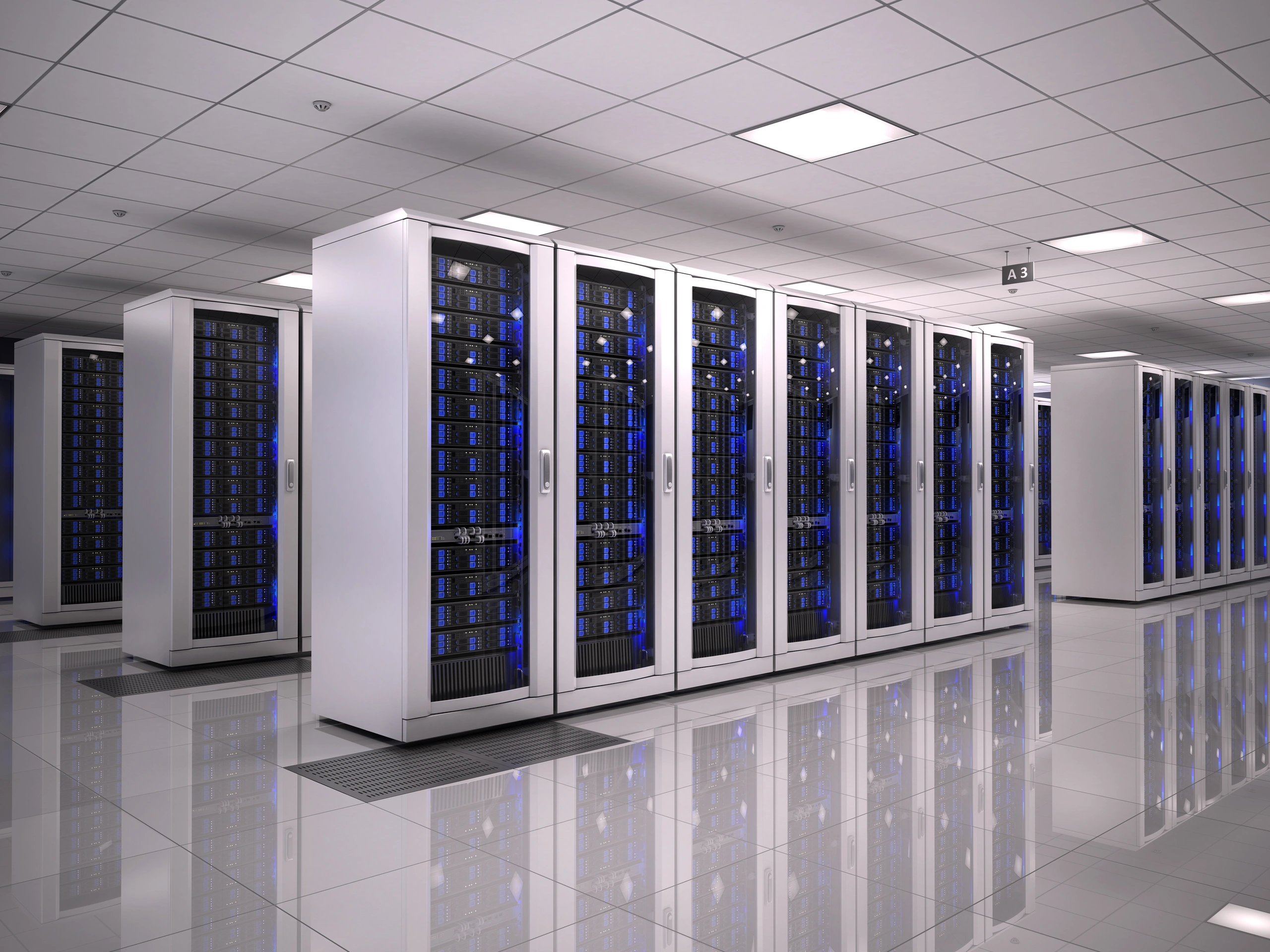 Rows of white server racks with glass doors reflecting on a polished gray floor.