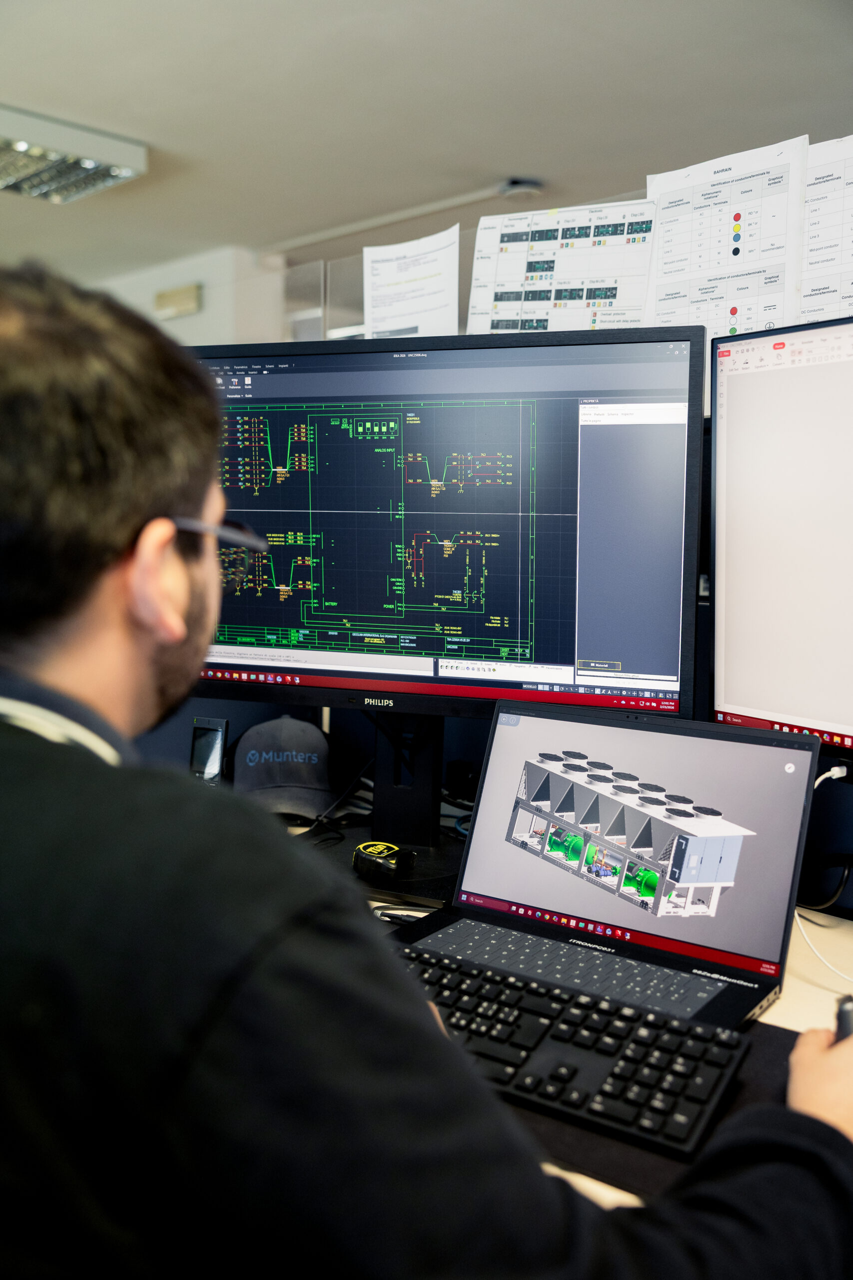 Engineer reviewing technical designs for a data center cooling system