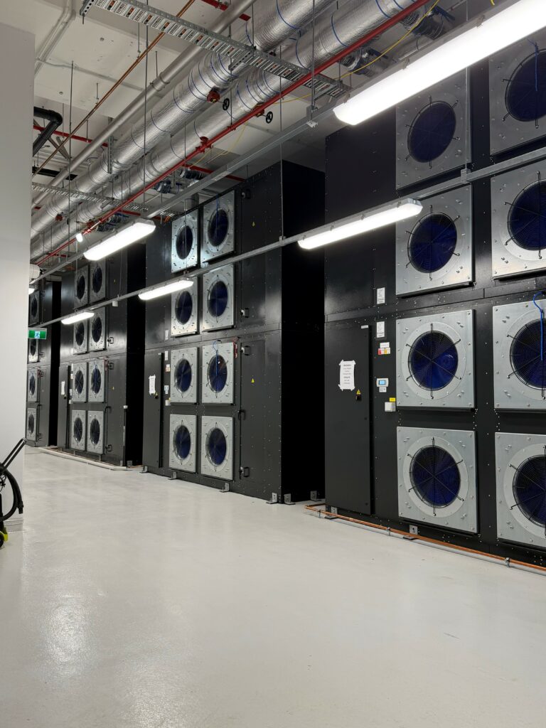 Stacked Munters fan wall units installed along a service corridor in a Sydney data center.